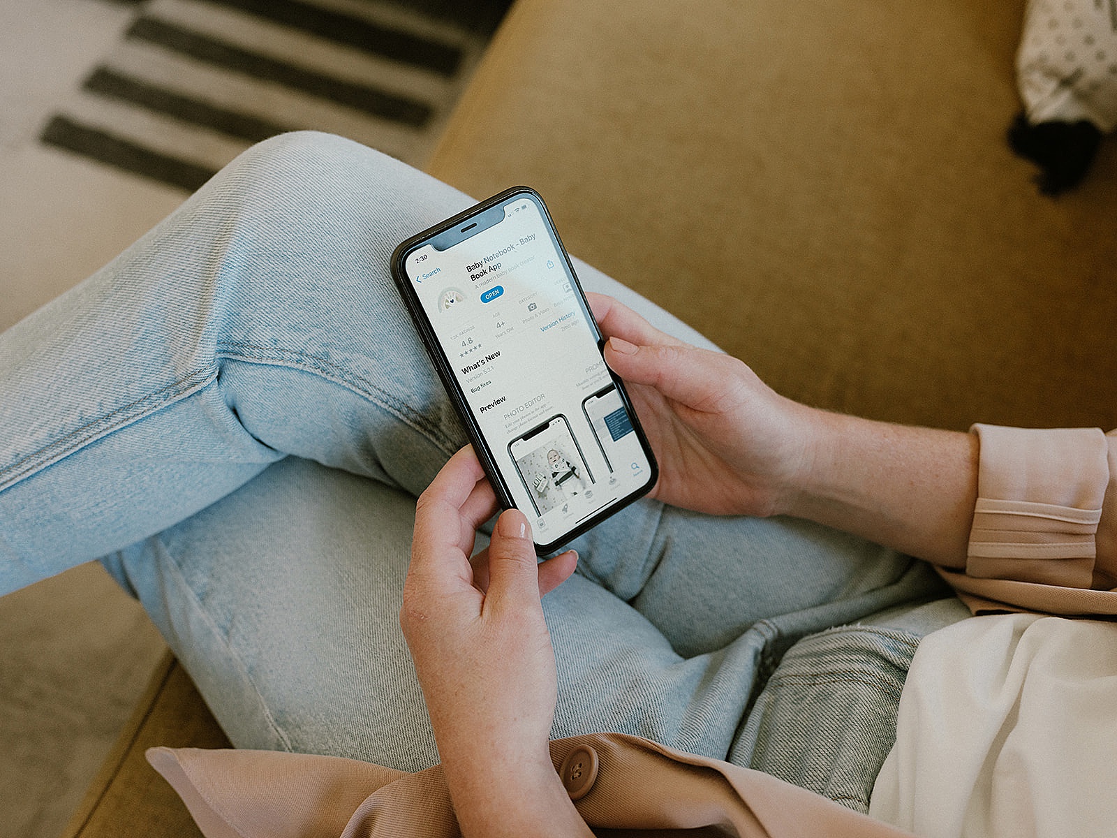A woman scrolls through an app for parents.