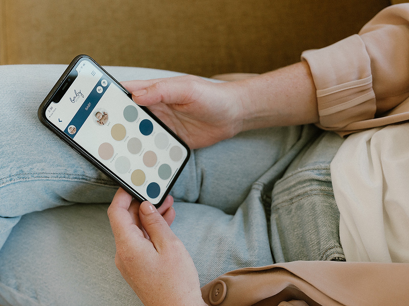 A woman customizes a digital memory book on her phone.