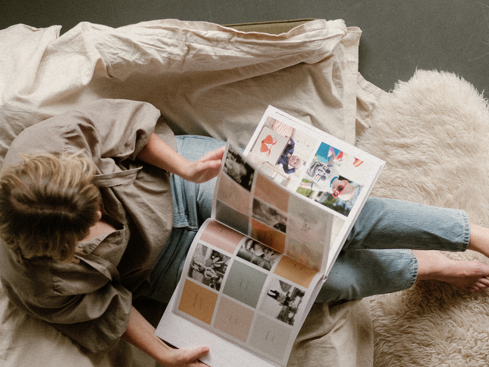 A mother flips through a memory book with toddler quotes and photos.