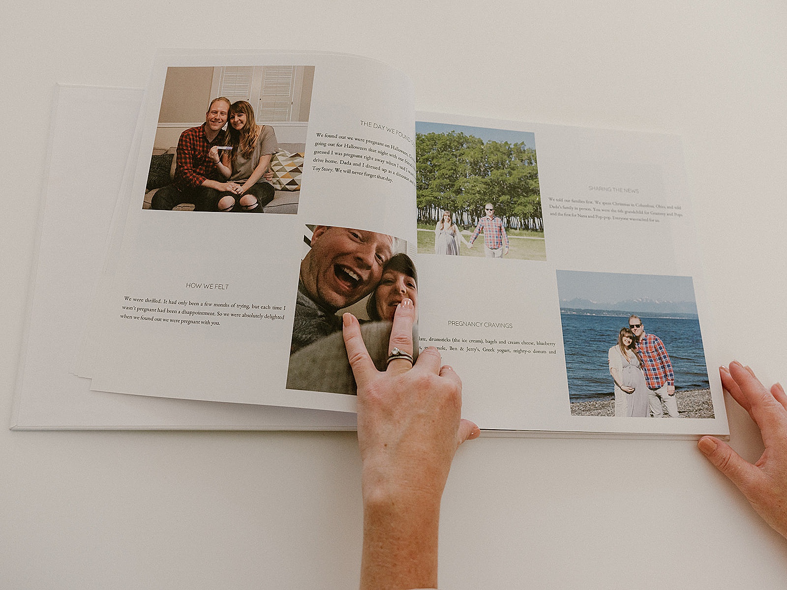 A pregnancy journal sits open to a timeline with text and pictures.